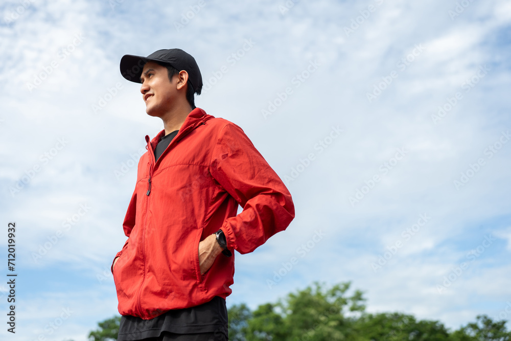 Young handsome asian man wearing sportswear standing post on running track at sport stadium outdoor. Portraits of Indian man jogging on the road. Training athlete outdoor concept. Young handsome asian man wearing sportswear standing post on running track at sport stadium outdoor. Portraits of Indian man jogging on the road. Training athlete outdoor concept.