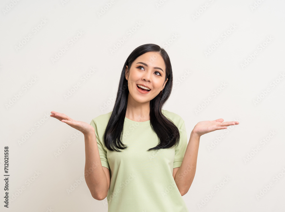 Beautiful smiling happy young asian woman in green shirt. Charming female lady open hands palm up holding something on isolated white background. Asian woman cute Pretty people looking blank space. Beautiful smiling happy young asian woman in green shirt. Charming female lady open hands palm up holding something on isolated white background. Asian woman cute Pretty people looking blank space.