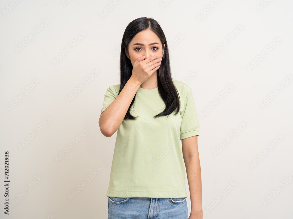 Shocked face asian woman while hands close mouth keep quiet. Can't speak no vote. Young latin female worried expression keep the secret. Asian woman standing on white background Shocked face asian woman while hands close mouth keep quiet. Can't speak no vote. Young latin female worried expression keep the secret. Asian woman standing on white background