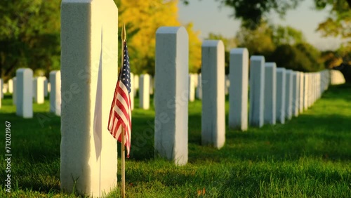 members graves with American flags at sunset in the National Cemetery. Unknown soldier grave. Veteran cemetery and U.S. flag. Military Appreciation Holidays concept photo