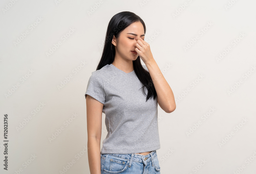 Young asian beautiful woman hand rubbing eyes she's feeling depressed stress headache be tired from working standing on isolated white background she has unwell unhealthy problems. Young asian beautiful woman hand rubbing eyes she's feeling depressed stress headache be tired from working standing on isolated white background she has unwell unhealthy problems.