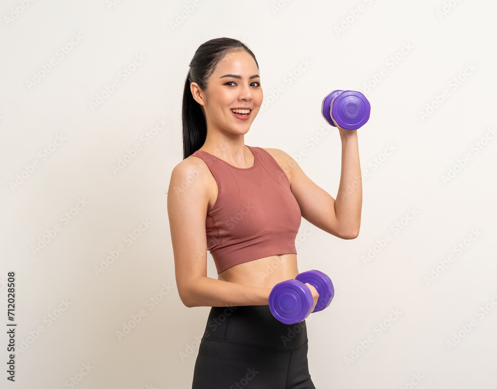 Young beautiful asian woman with sportswear exercises workout with dumbbells on isolated white background. Portrait happy healthy slim fit and firm latin attractive sporty woman weight training Young beautiful asian woman with sportswear exercises workout with dumbbells on isolated white background. Portrait happy healthy slim fit and firm latin attractive sporty woman weight training