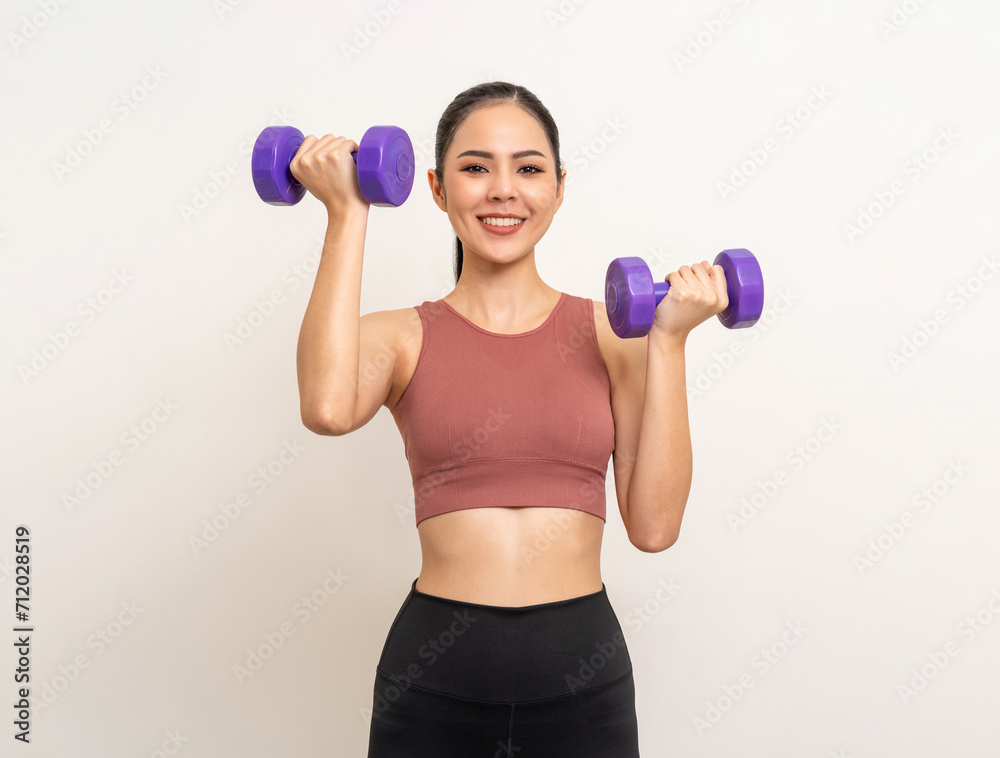 Young beautiful asian woman with sportswear exercises workout with dumbbells on isolated white background. Portrait happy healthy slim fit and firm latin attractive sporty woman weight training Young beautiful asian woman with sportswear exercises workout with dumbbells on isolated white background. Portrait happy healthy slim fit and firm latin attractive sporty woman weight training
