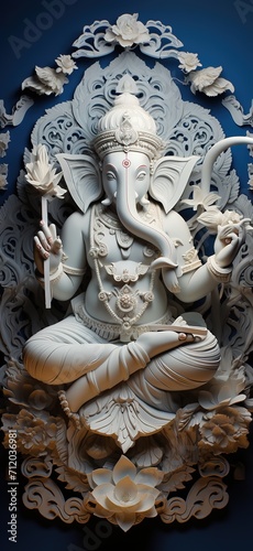 White marble statue of Hindu god Ganesha sitting on lotus flower