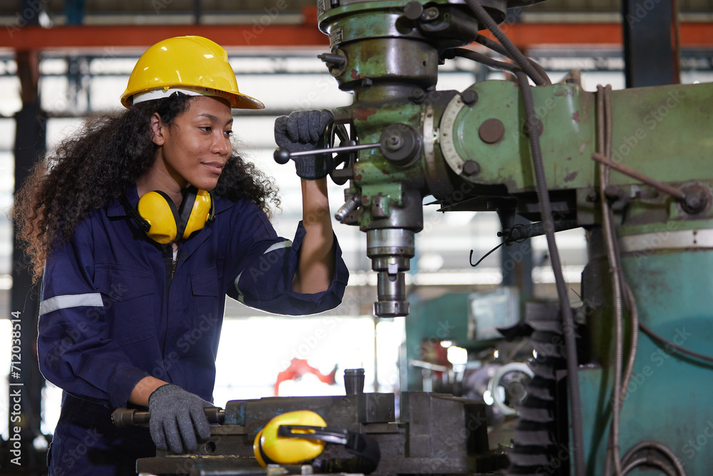 factory worker or technician checking and control lathe machine in factory