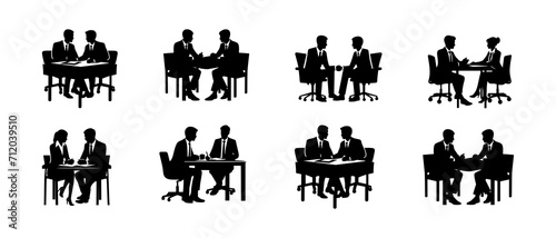 Silhouettes of Business Professionals Engaging in Discussion and One-on-One Meetings in an Office Environment	