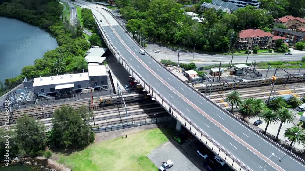 Drone aerial pan landscape train on tracks train-line railway Gosford station waterfront infrastructure travel transport Brian McGowan Bridge Central Coast Australia Drone aerial pan landscape train on tracks train-line railway Gosford station waterfront infrastructure travel transport Brian McGowan Bridge Central Coast Australia