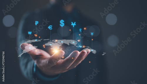 Fotografia Global currency exchange concept, Businessman holding virtual world map and dollar yuan yen euro and pound sterling sign