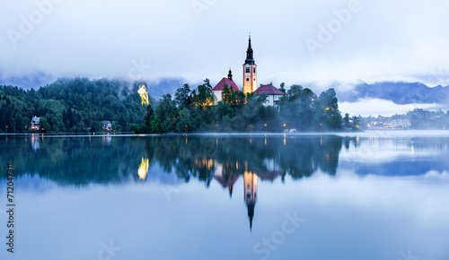 Lake Bled Slovenia with the small island in the middle of the lake and the old church and the castle in the background. photo