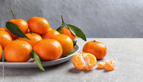 Fresh juicy tangerines on light gray background with copy space