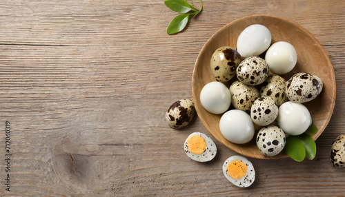 Unpeeled and peeled boiled quail eggs in bowls on wooden table, flat lay photo