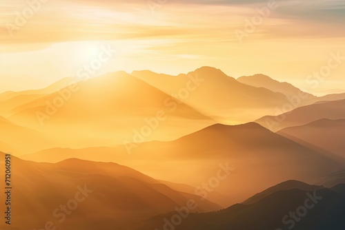 Golden sunrise illuminating at misty mountains.