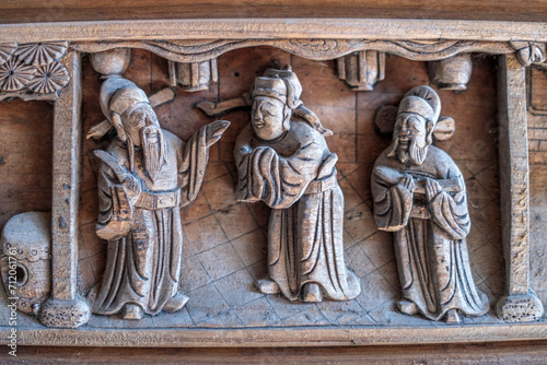 Close-ups of traditional wooden carving figures in ancient Chinese architecture