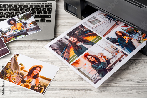 Computer laptop and printer on table. Printing photos