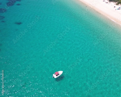 Top down of boat in crystal-clear water in Shoal Bay, NSW, Australia © Andrew