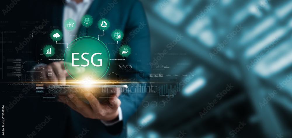 Social investment business concept. ESG and environmental governance, businessman use tablet green ESG icon, sustainable global clean energy, sustainable and ethical corporate development. Social investment business concept. ESG and environmental governance, businessman use tablet green ESG icon, sustainable global clean energy, sustainable and ethical corporate development.