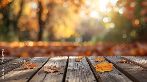 The empty wooden table top with blur background of autumn. Exuberant image.