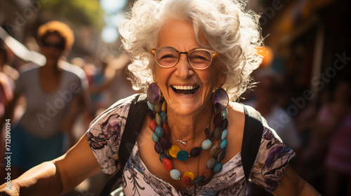 A joyful senior woman with white curly hair  laughing ecstatically  wearing colorful jewelry  out in a sunny  vibrant street.