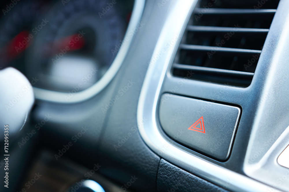 Emergency signal button on the dashboard of a modern car. Close-up.