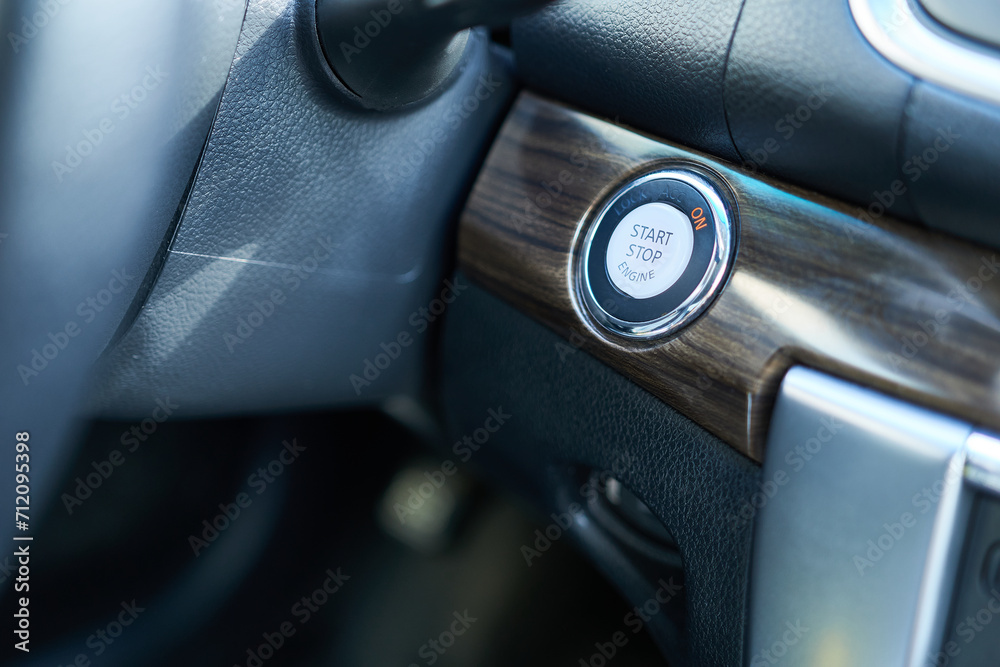 A close-up of the ignition button on the car's dashboard. Start button.
