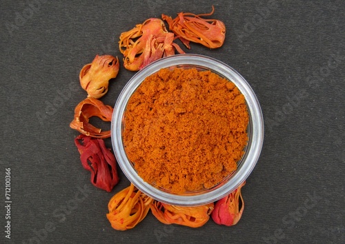Fototapeta Naklejka Na Ścianę i Meble -  Mace spice powder in a bowl on black background top view 