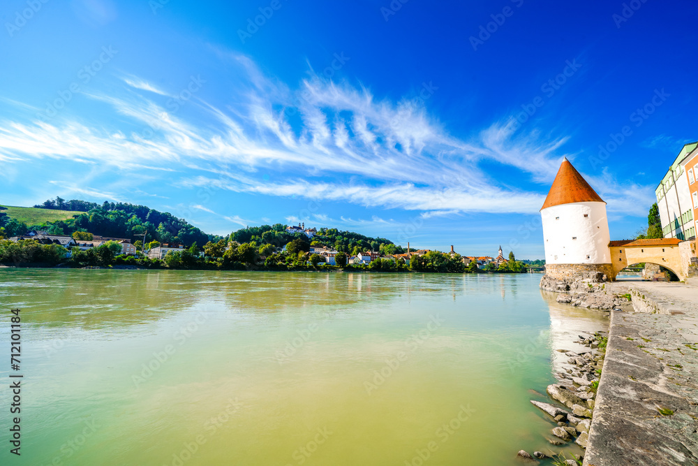 View of the Inn River and the Schaiblingsturm in Passau. Historic round tower of the city with the surrounding landscape. Old defense tower.
