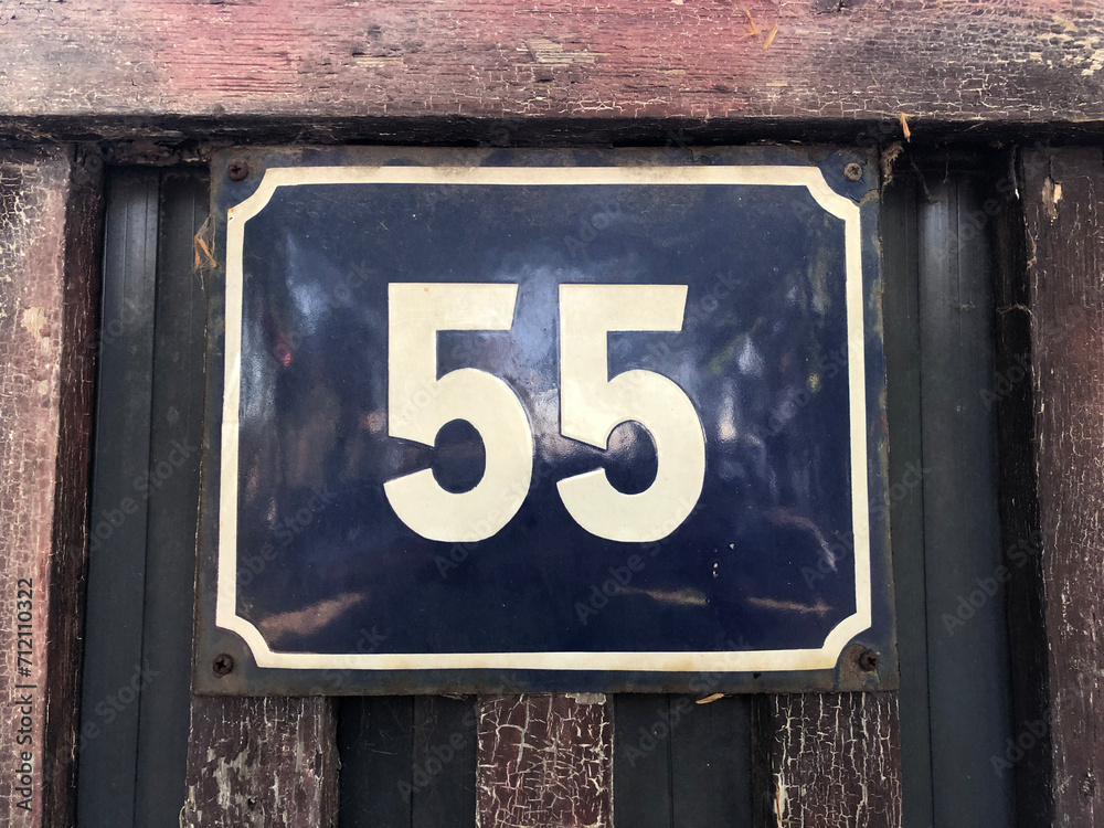 Blue numberplate that says number 55 Blue numberplate that says number 55