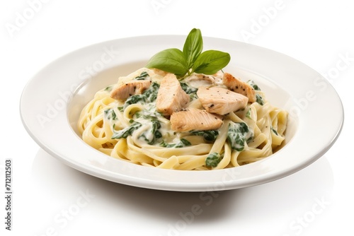 Selective focus on white background with Chicken Alfredo Pasta and Spinach