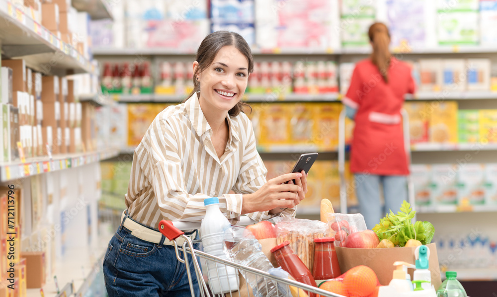 Portrait of a woman using a smartphone at the grocery store