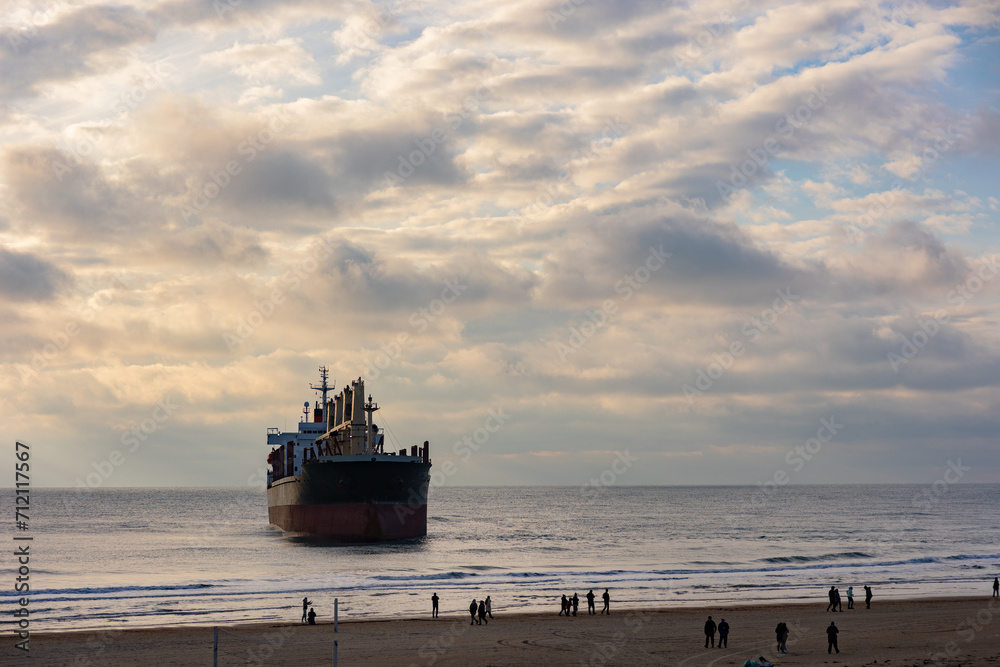 A large cargo sea ship sails on the ocean among the waves