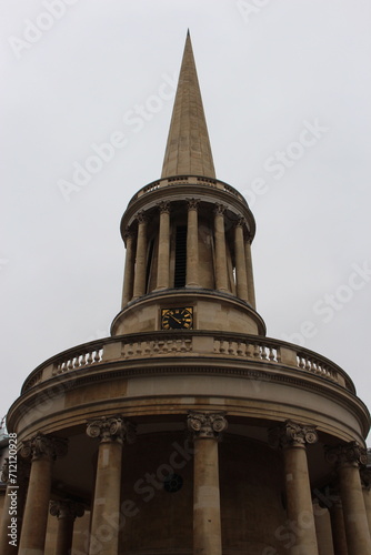 Iconic London Church steeple of All Souls Langham Place, a 19th-century, working evangelical church, designed by John Nash, with an ornate galleried hall. Seen on grey, overcast day. Steeple on gray