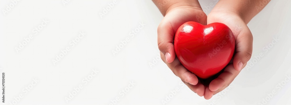 Fototapeta premium Kid boy Hand holding heart. Love concept.