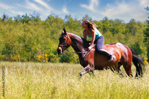 Woman women with horse riding horses on a summer meadow without a saddle.