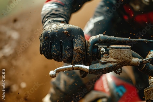 Detailed view of a motocross rider's hand gripping the throttle, emphasizing control and adrenaline in the race