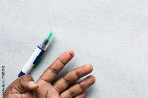 Bleeding finger for blood test, finger pricked using lancet to collect blood for test