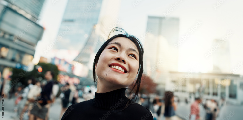 Fototapeta premium Japanese woman, city and happy with thinking, ideas and outdoor for vacation, travel or journey. Girl, person and smile on metro street, road or urban sidewalk for memory, vision or outdoor in Tokyo