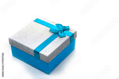 Beautiful blue gift box with a bow isolated on white. Surprise, gift, attention.