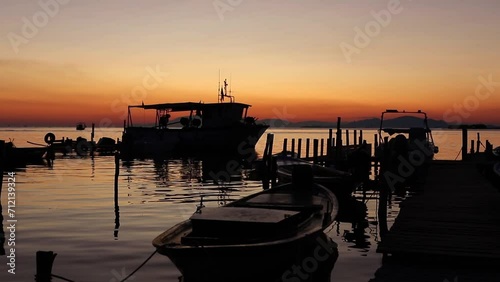 Sunset at harbor with fishing boats photo