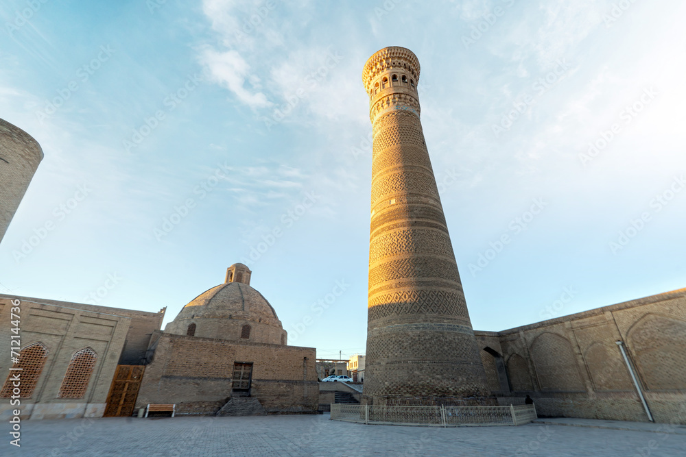 Awesome view of the Kalan Minaret of Po-i-Kalan complex in Bukhara, Uzbekistan. The ancient brick tower is popular tourist attraction of Central Asia