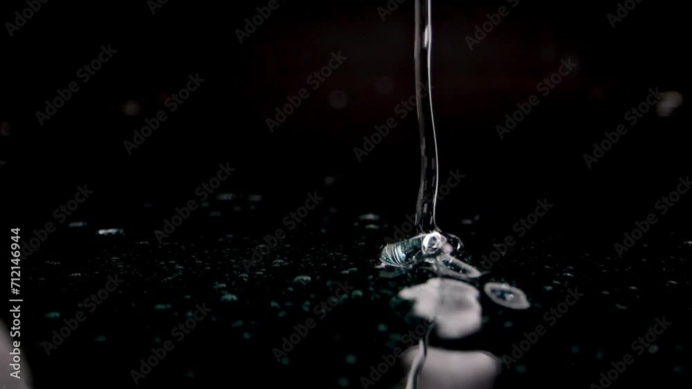 A glossy, blue-tinged gel spreads over a dark surface, perfect for illustrating high-end hygiene or beauty products.