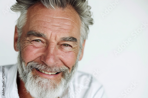 a closeup photo portrait of a handsome old mature man smiling with clean teeth