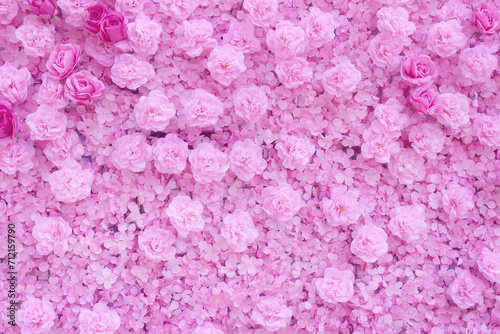 Fototapeta Naklejka Na Ścianę i Meble -  Light pink carnation and rose artificial flowers on wall soft background