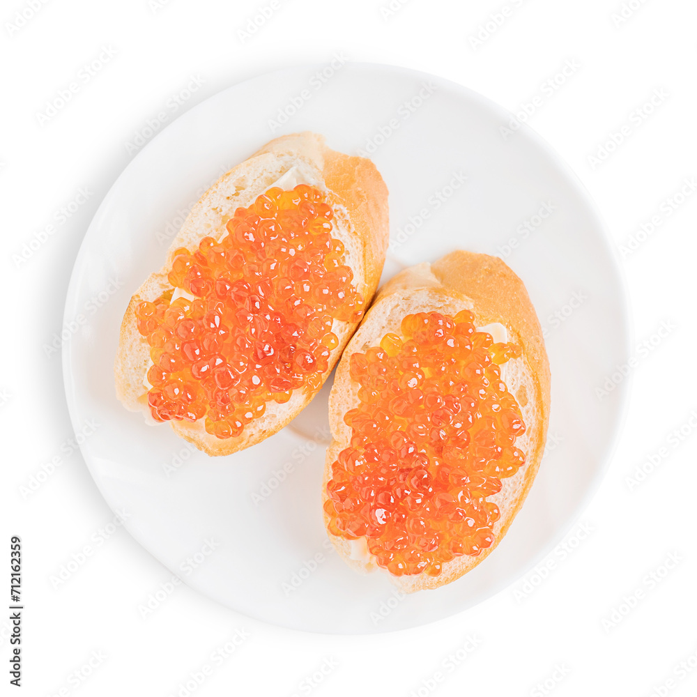 Red salty salmon caviar or fish roe on two sliced loaf of bread or canape with butter on ceramic round plate isolated on white background served for healthy breakfast full of protein and vitamins