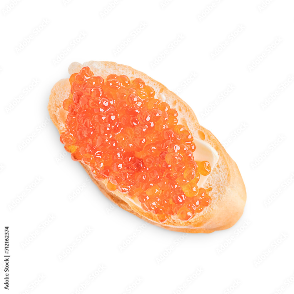 Red salty natural salmon caviar or fish roe on single slice loaf of bread or crusty canape with butter isolated on white background served for healthy breakfast full of protein, fat and vitamins