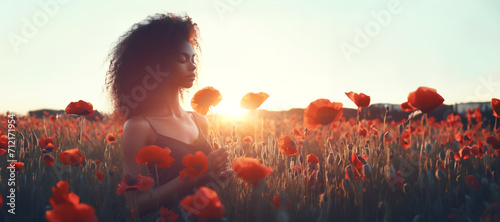 young beautiful woman in summer dress in poppies field