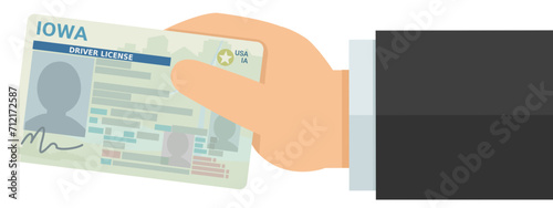 A hand presents a driver's license from the US state of Iowa in flat design style