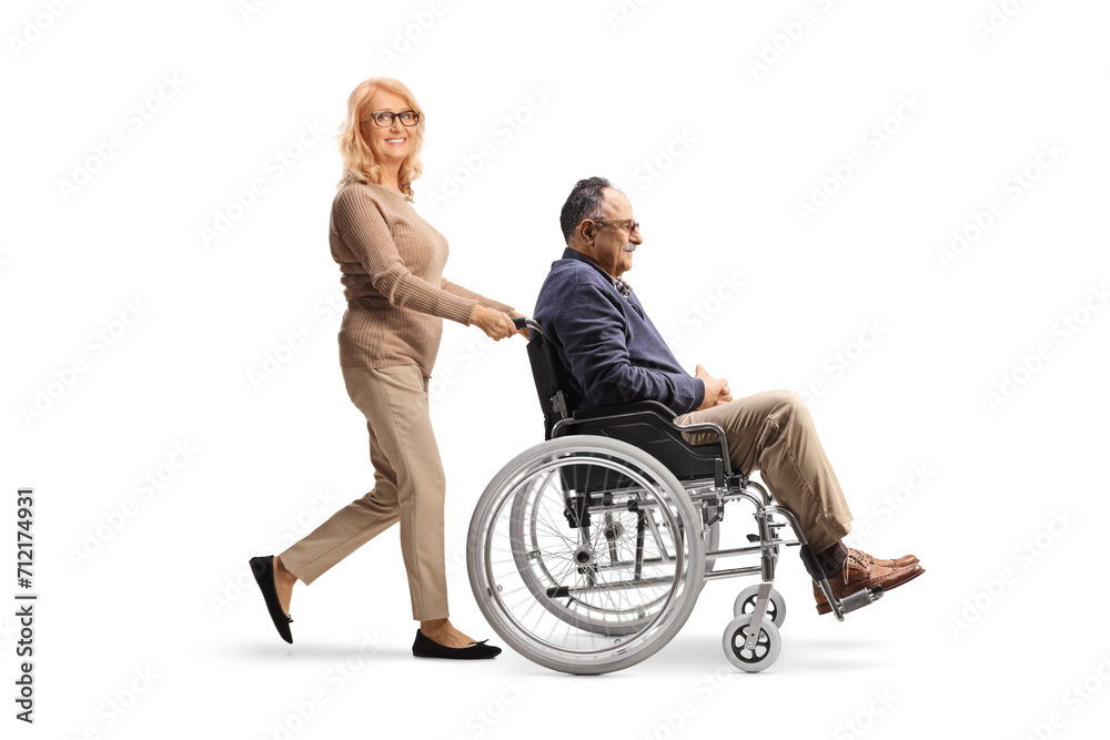 Woman pushing a man in a wheelchair Woman pushing a man in a wheelchair