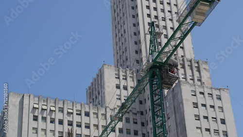 Wallpaper Mural Dynamic Aerial Footage Capturing a Crane in Motion, Busily Constructing a Building in the Heart of Buenos Aires, Showcasing the Urban Growth and Development in the Bustling City Center during daytime Torontodigital.ca