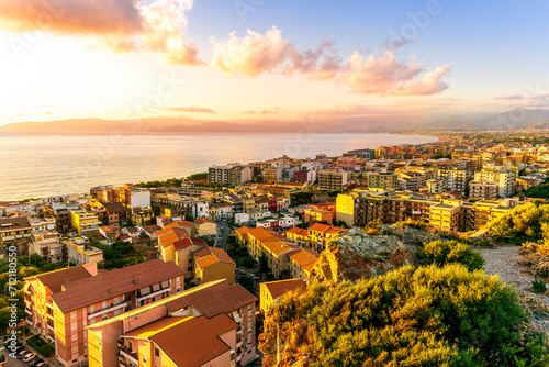 panoramic summer travel view from a hill to  beautiful sea coast historical town with port  amazing ocean bay and gulf and beautiful mountains with scenic sunset on background.