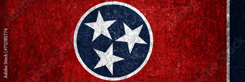 Close-up of the grunge Tennessee State  flag. Dirty Tennessee State  flag on a metal surface.